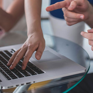 Asian team engaged in innovative tech development (Innovation)